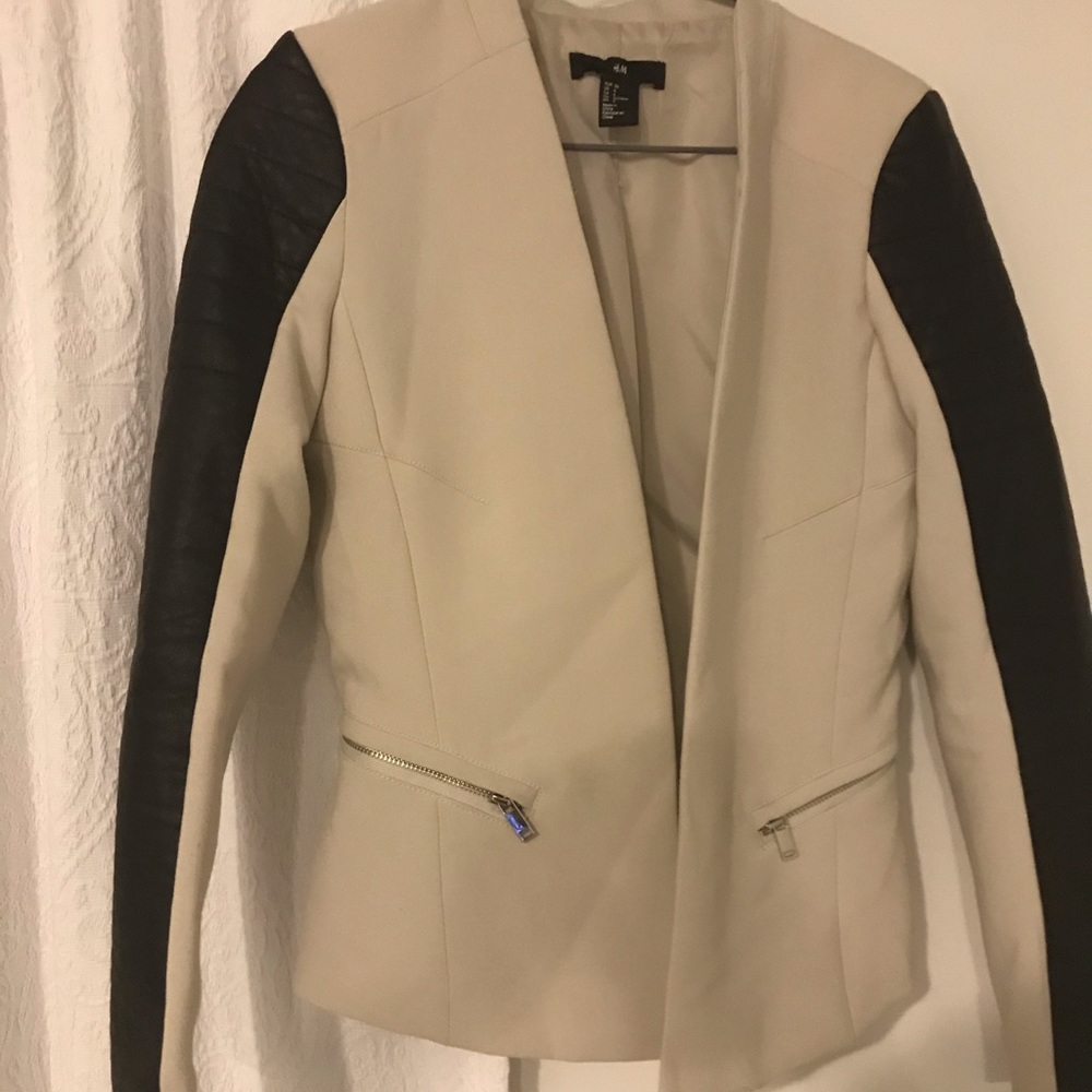 Off white coat with black leather-type sleeves